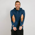 Man wearing navy blue zip hoodie with large elbow cutouts over black pants, smiling at camera. | Model is 5'8" 165lbs wearing size M