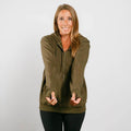 Woman wearing olive green IV zip hoodie with front zipper and thumb holes, front view.