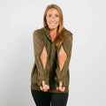 Woman wearing olive green IV zip hoodie with open side zippers for medical access, front view.