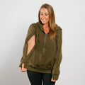 Woman wearing an olive green zip-up hoodie with black pants against a white background. #NEW | Model is 5'3" 130lbs wearing size S