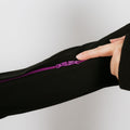 Person wearing black IV zip hoodie with purple arm zipper access feature visible.