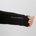 Person wearing black IV zip hoodie with left sleeve zipper access detail visible on arm.
