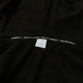 Close-up of black IV zip hoodie tag showing "Rare. Not imaginary" branding detail.