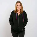 Woman wearing black IV zip hoodie with pink drawstring accents, front view.