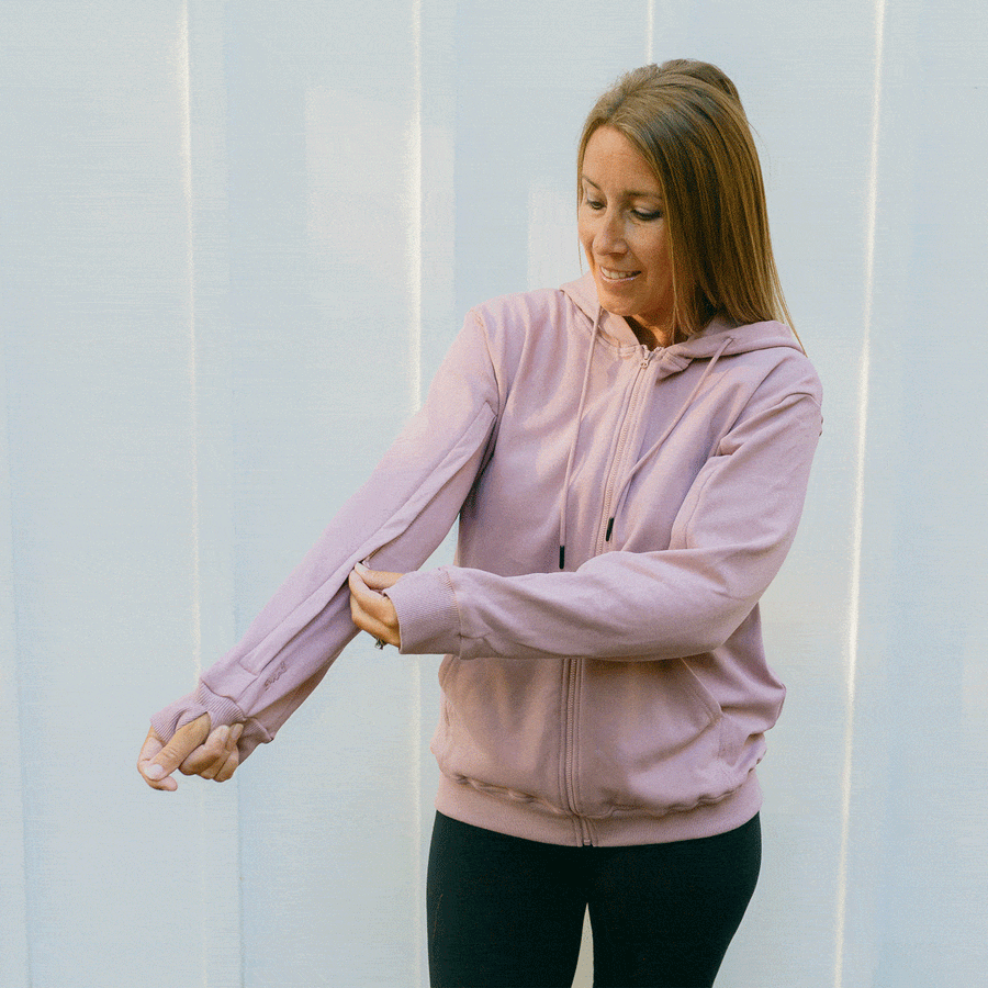 Woman wearing lavender IV zip hoodie with sleeve zipper access feature  visible.