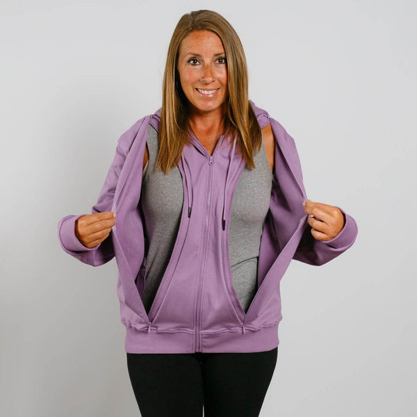 Woman wearing a lavender zip hoodie over a gray shirt with hands holding the hood open. | Model is 5'3" 130lbs wearing size S 