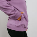 Purple zip hoodie with orange interior lining visible through open pockets and sleeve cuffs.