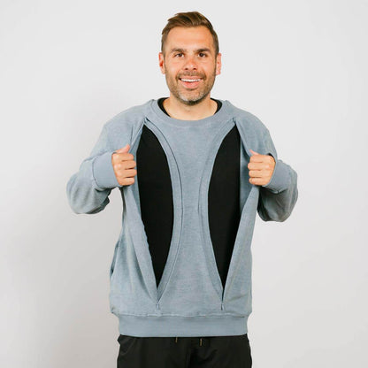 Man wearing open light blue crewneck sweatshirt over black shirt, smiling at camera. | Model is 5'8" 165lbs wearing size M