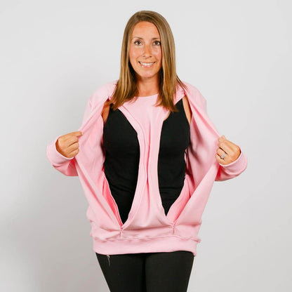 Woman wearing pink zip-up crewneck over black shirt and black pants, smiling at camera. | Model is 5'3" 130lbs wearing size S