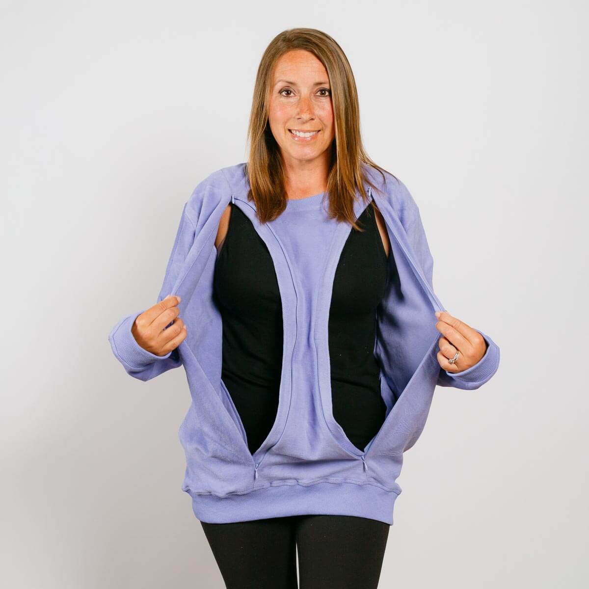 Woman wearing light purple zip-up hoodie over black shirt, demonstrating open front access pockets. | Model is 5'3" 130lbs wearing size S