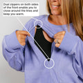 Woman in light purple crewneck demonstrates dual front zippers that open from top and bottom.