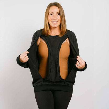 Woman wearing a black crewneck with cut-out design on a plain background #NEW | Model is 5'3" 130lbs wearing size S