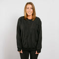 Woman wearing charcoal gray multi-access crewneck with front view showing adaptive zipper placement.