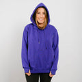 Woman wearing a purple hoodie with drawstrings and black pants against a white background.