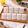 Wooden organizer tray with ten clear pill pouches labeled for times of day and doses in lifestyle setting.