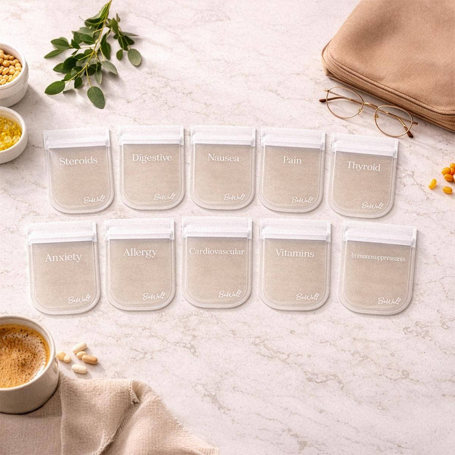 Ten beige pill pouches labeled with medical conditions arranged on marble surface in lifestyle setting.
