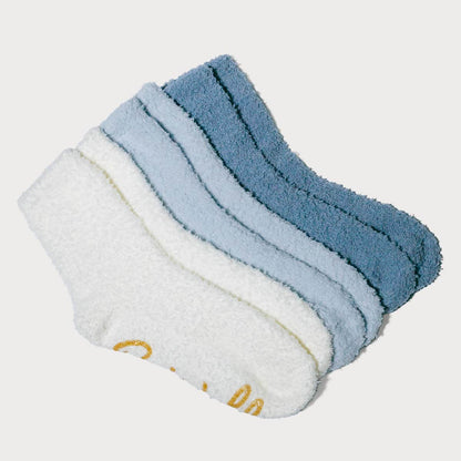 Pair of blue and white baby socks on a light gray background #NEW