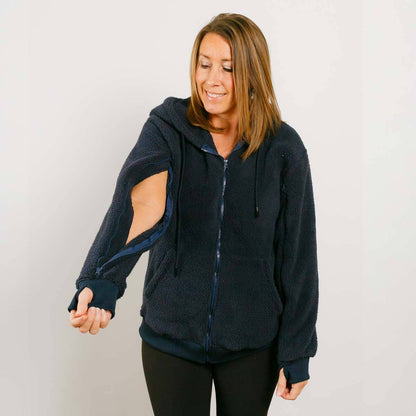 Woman wearing a dark blue hoodie with cut-out sleeves on a plain background #NEW | Model is 5'3" 130lbs wearing size S
