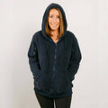 Woman wearing dark navy sherpa zip hoodie with hood up, front view.
