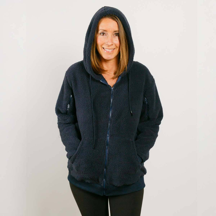 Woman wearing dark navy sherpa zip hoodie with hood up, front view.