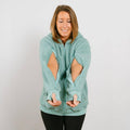 Woman wearing sage green sherpa zip hoodie with arm access openings, front view.