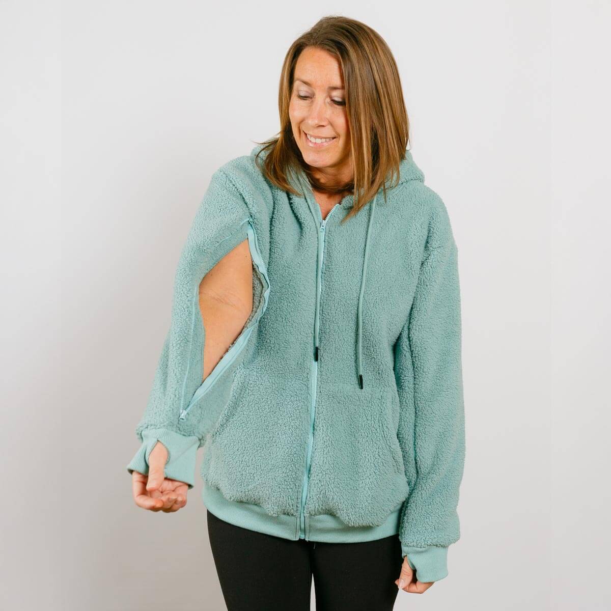Woman wearing a light blue hoodie with cut-out design on a plain background #NEW | Model is 5'3" 130lbs wearing size S 