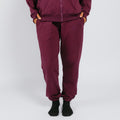 Person wearing maroon sweatpants with cuffed ankles and black socks against a white background. | Model is 5'3" 130lbs wearing size S