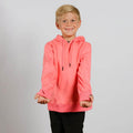 Young child with blonde hair wearing a bright pink hooded sweatshirt and black pants, smiling at camera.