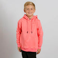 Young boy wearing a bright coral pink hoodie with drawstrings, smiling at camera.